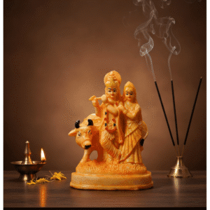 Buy the divine 9 Inch Polyresin Radha Krishna with Cow Idol in Golden Orange