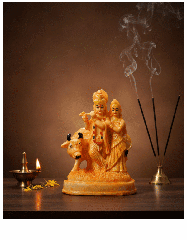 Buy the divine 9 Inch Polyresin Radha Krishna with Cow Idol in Golden Orange