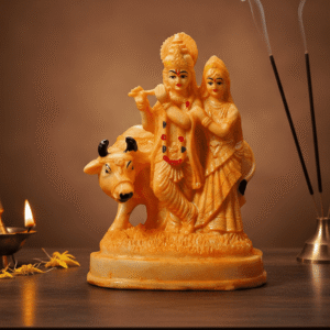 Buy the divine 9 Inch Polyresin Radha Krishna with Cow Idol in Golden Orange